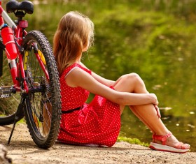 Sit and rest woman with parked bicycles Stock Photo