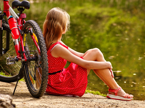 Sit and rest woman with parked bicycles Stock Photo