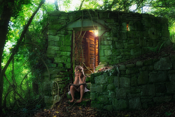 Sitting in the stone house before reading the little girl Stock Photo
