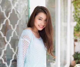 Smile Asian girl in front window HD picture