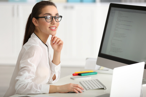 Smiling female programmer working in the office Stock Photo 02