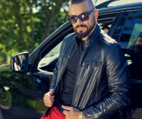 Standing beside the car cool man Stock Photo