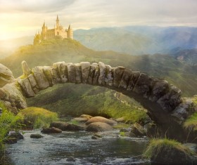 Stone arch bridge with the mountains of the castle Stock Photo
