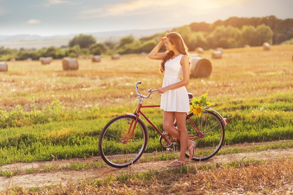 The girl pushing the bike in the field HD picture