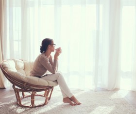 The girls at the window are drinking coffee Stock Photo