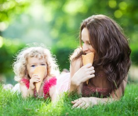 The mother and daughter who eat ice cream on the grass Stock Photo