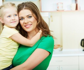 The mother in the kitchen with her daughter Stock Photo