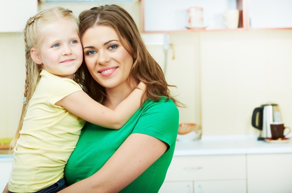 The mother in the kitchen with her daughter Stock Photo