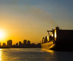 Twilight city with seaside freighter Stock Photo