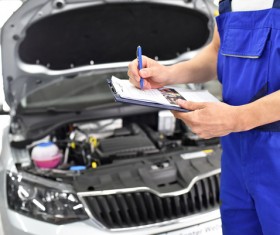 Vehicle maintenance staff do car maintenance records Stock Photo