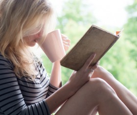 While drinking coffee while reading girls Stock Photo