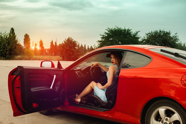 Woman sitting in red sports car Stock Photo 01