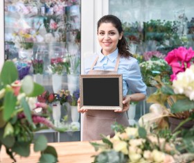 Working in a flower shop Woman hand holding a blackboard Stock Photo
