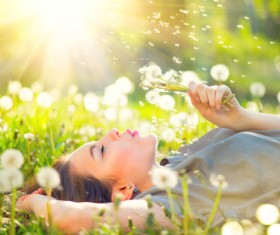 Blowing dandelion woman Stock Photo