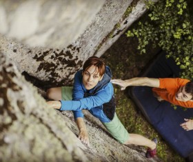 Coaches and free climbing woman Stock Photo
