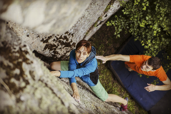 Coaches and free climbing woman Stock Photo