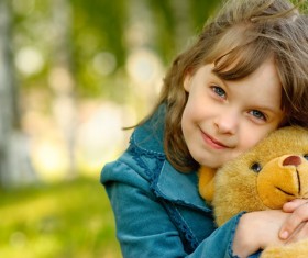 Cute little girl holding a teddy bear Stock Photo