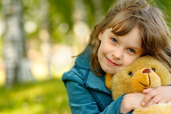 Cute little girl holding a teddy bear Stock Photo
