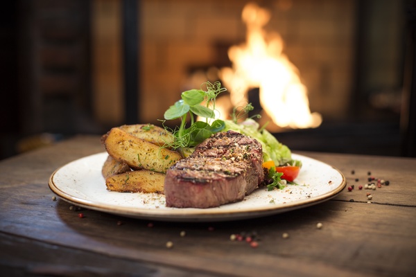 Delicious steak with potato vegetables Stock Photo