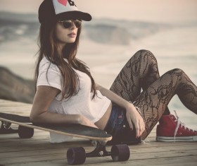 Fashion girl with skateboard Stock Photo
