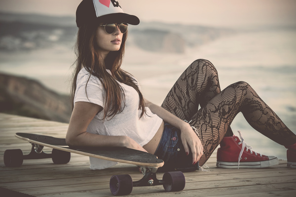 Fashion girl with skateboard Stock Photo