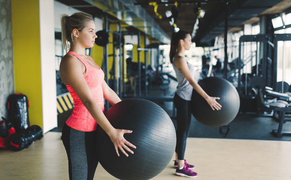 Girl holding a fitness ball Stock Photo
