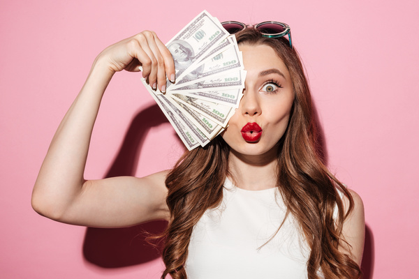 Holding a dollar woman Stock Photo