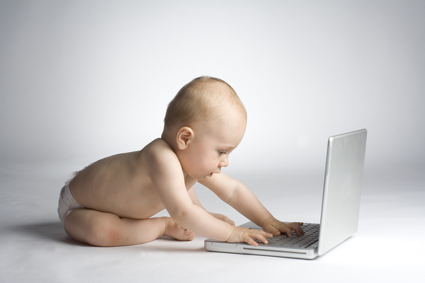 Playing computer baby Stock Photo