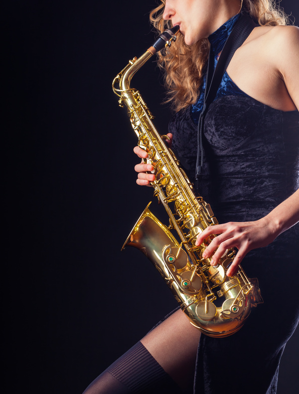 Saxophone playing woman Stock Photo