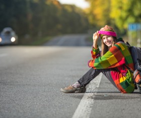 Sitting on the roadside rest of the woman Stock Photo