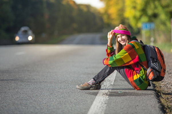 Sitting on the roadside rest of the woman Stock Photo