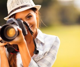 Smiling female photographer Stock Photo