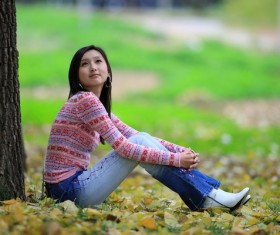 The girl sitting under the tree Stock Photo