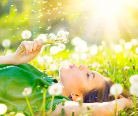 The sun blowing dandelion woman Stock Photo