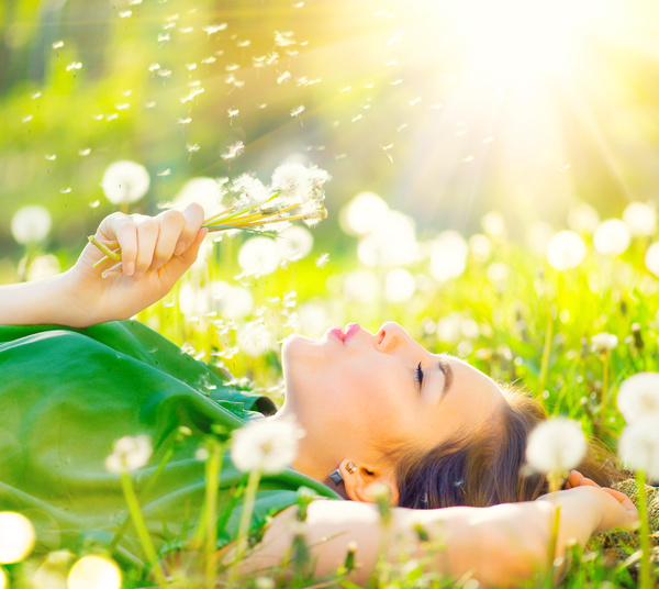 The sun blowing dandelion woman Stock Photo