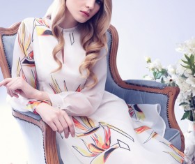 Young blonde girl sitting on the couch Stock Photo 04