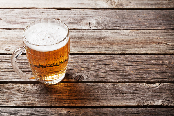 glass of beer on a wooden table Stock Photo