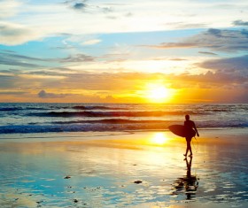 Beautiful dawn with surfers Stock Photo