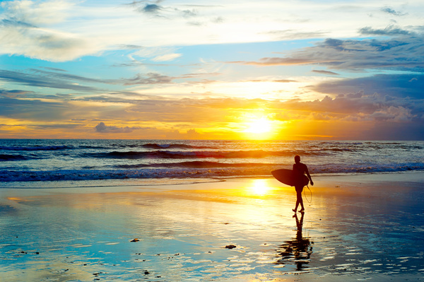 Beautiful dawn with surfers Stock Photo