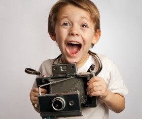 Child holding a vintage camera HD picture