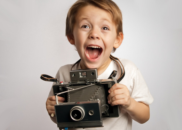 Child holding a vintage camera HD picture