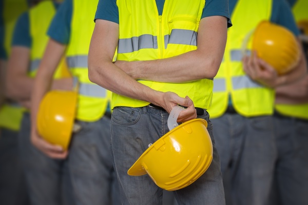 Construction worker holding a helmet