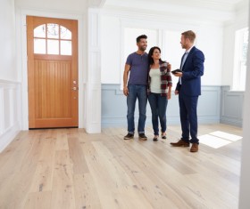 Couples talking to house developers Stock Photo