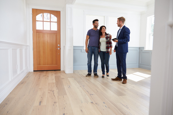 Couples talking to house developers Stock Photo
