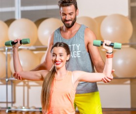 Fitness girl with a personal trainer Stock Photo 02