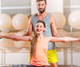 Fitness girl with a personal trainer Stock Photo 04