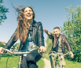 Happy couple riding a bike Stock Photo