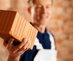 Man holding hollow brick Stock Photo