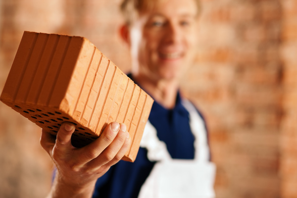 Man holding hollow brick Stock Photo