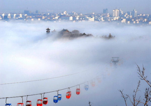 Mist-shrouded Penglai Pavilion and funicular Stock Photo